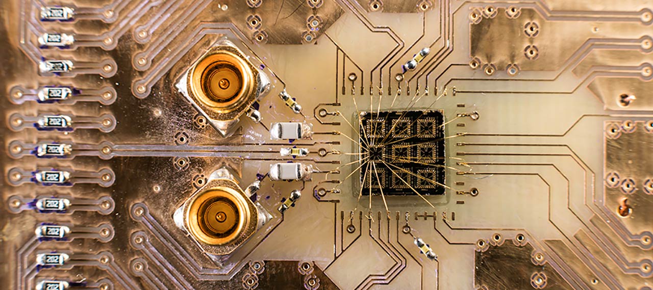 A quantum processor semiconductor chip connected to a circuit board.